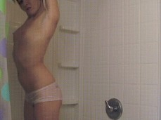 Cute brunette strips in the shower gif