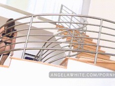 Angela White in lingerie descending the stairs from behind gif