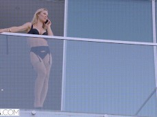 Nicole Aniston talking on phone in lingerie on balcony gif