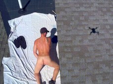 Stiff cock from behind balls showing on roof in public gif