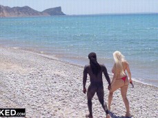 Angel Wicky strolls on beach in thong bikini with naked  stud gif