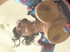 lisa ann presses her tits against a glass table gif