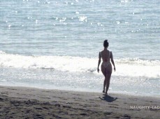 Naughty Lada walking down to the waves in thong swimsuit gif