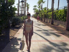 Naughty Lada on the boardwalk in sheer white swimsuit 02 gif