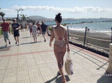 Naughty Lada walking on boardwalk in thong swimsuit 01 gif