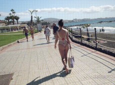 Naughty Lada walking on boardwalk in thong swimsuit 02 gif
