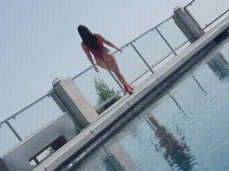 Angela White struts past in thong swimsuit gif