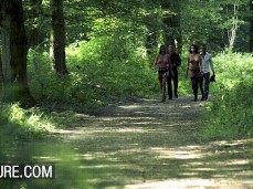 Anissa Kate and friend walking topless in thongs and stockings in forest gif