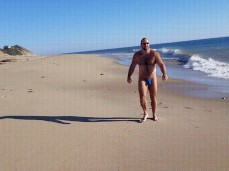 HAiry, bearded, beefy Boatinron walking on the beach in a tiny bikini 0032 gif