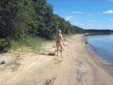 Collecting sticks on the beach in thong bikini gif