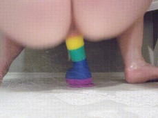 She Slides her Sweet Wet Slit Up n Down a Big Rubber Rainbow Dick gif