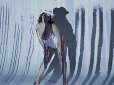 Natasha Nice cowgirl dancing in front of Pure Taboo sign gif