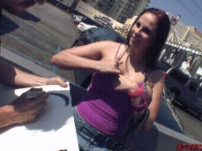 Gianna Michaels gives a quick tit flash to street sketch artist gif
