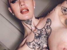 tattooed buxom babe cuts her hair with clipper to music showing huge tits gif