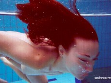 Woman swimming nude,  kicking the camera gif