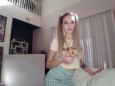 Lily Larimar Sits Down On The Couch With A Cookie And Short Skirt gif