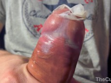A big dicked guy shows off a cum filled condom and play with it gif