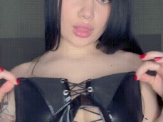 A girl with big breasts in a BDSM costume shows how to suck a huge dick gif