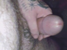 Playful, beefy, hairy, tatted Snowhoe37 stroking his thick, hot-headed cock gif