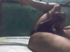 Slim, smooth Latin American student jerking his big uncut cock in the dorm gif