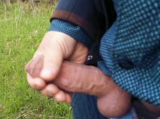 Out of the birch grove, a dude emerged -- stroking his big, fat, uncut cock gif