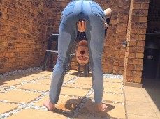 Bent over peeing through her jeans while smoking gif