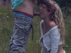 Gorgeous blonde girl on knees sucking cock in the middle of the field gif